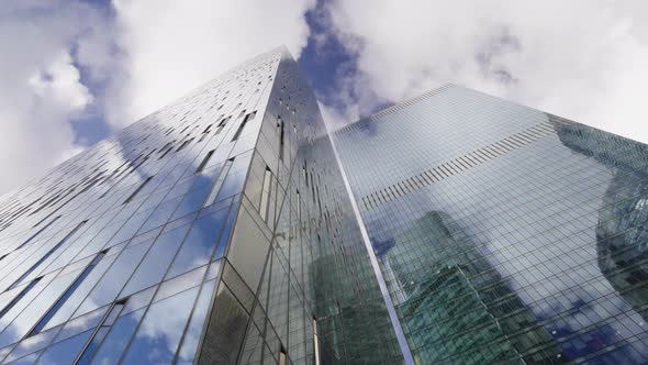 high-rise buildings of business centers against the background of fast-moving clouds