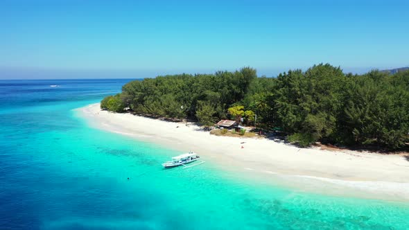 Wide angle above clean view of a white sand paradise beach and aqua blue ocean background in best qu