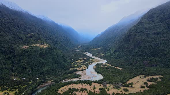 Aerial view truck left in the Cochamo Valley on a cloudy day. Cochamo River between mountains.