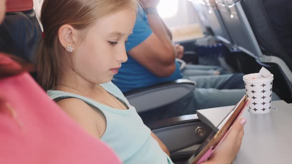 Adorable Little Girl Traveling By Plane