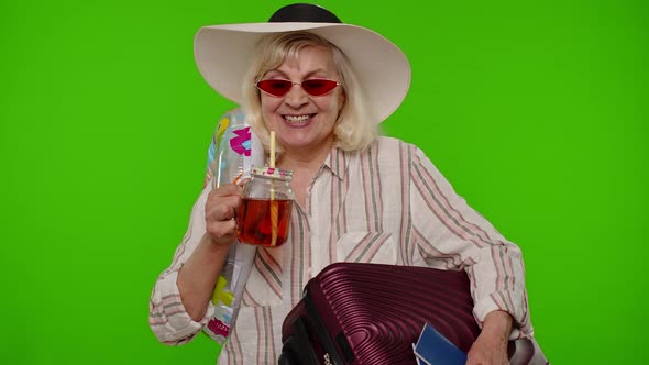 Mature Old Woman Tourist Passenger Drinking Cocktail Dancing Holding Passport Tickets Luggage