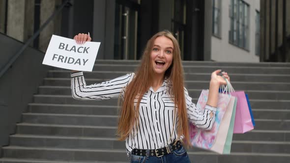 Cheerful Girl Showing Black Friday Inscription Text Advertisement. Online Shopping with Low Prices