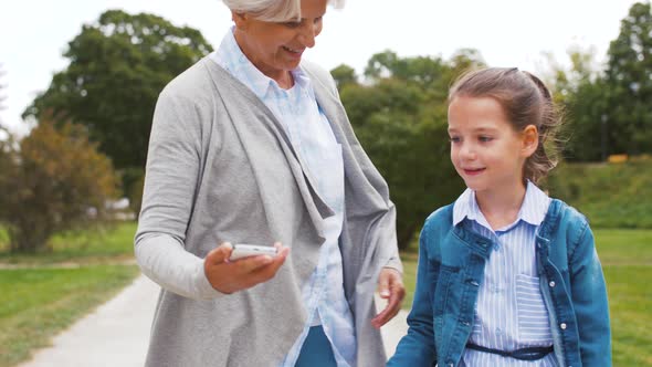 Grandmother and Granddaughter Take Selfie at Park 