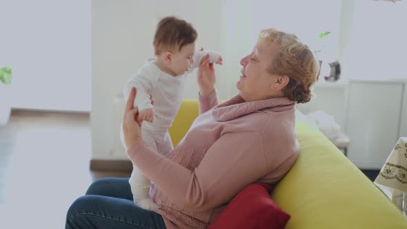 Grandmother with Her Cute Granddaughter Baby Smiling Talking Playing