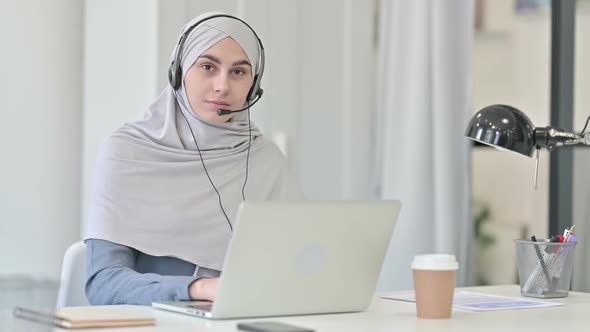 Young Arab Woman with Laptop Smiling with Headset