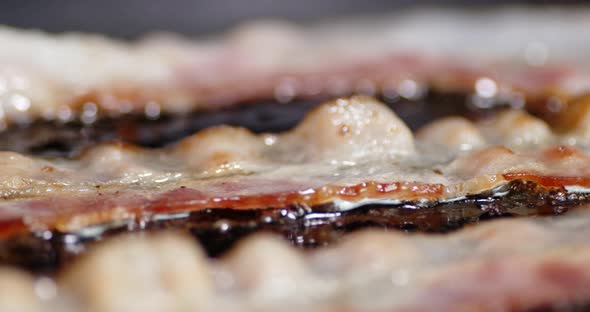 Bacon Slice Fried with Air Bubbles. A Slow Rotation 