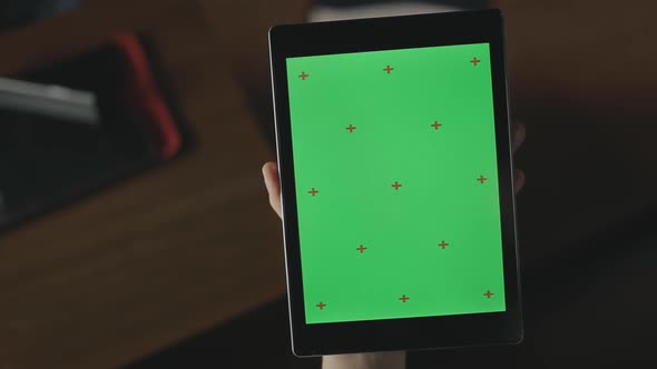 Female Hand Swiping Green Screen Tablet. Close Up Tablet with Chroma Key Screen