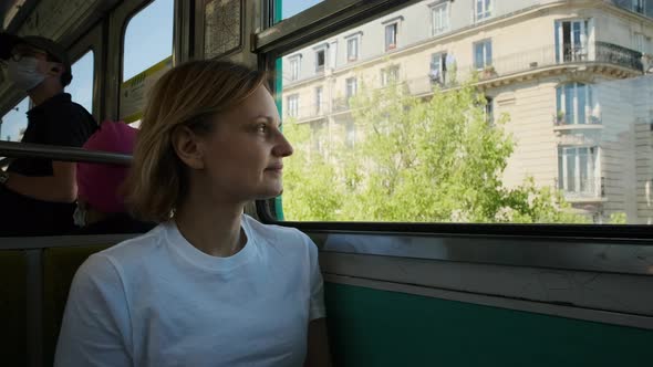 Tourist Woman Riding Metro Train at Paris Looking at Tower and Streets