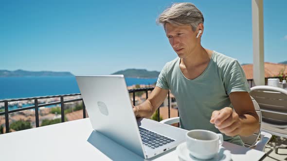 Man Freelancer or Businessman Wearing Earphones Holding Video Call Spiking with Client or Team