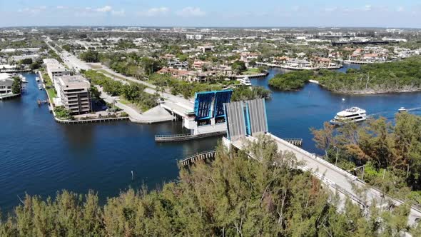 Aerial shoting along a bridge that has opened to let a large Yacht pass through