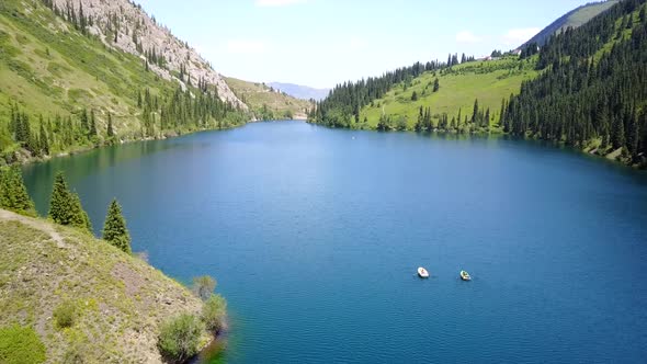 Kolsay Lake Among Green Hills and Mountains