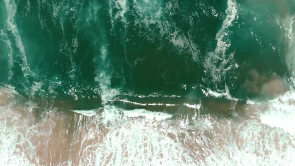 aerial drone showing endless wild sea breaking waves