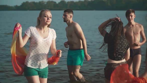 Company of Young People Is Resting on the River