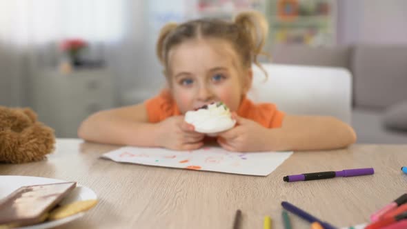 Adorable Female Child Eating Sweet Cream Cake Sitting Table, Childhood Happiness