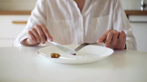 Large White Plate With One Peanut. Knife And Fork. I'll Eat A Tiny Nut! Weight Loss Concept