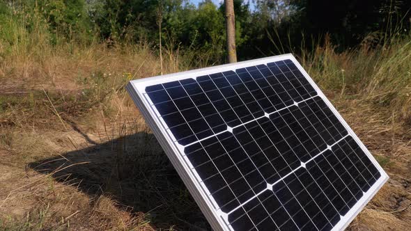 Portable Solar Panel Lying on the Ground Used in Tourism and for Camping