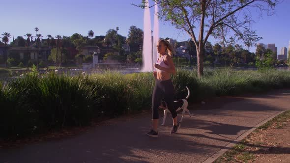 Attractive Woman Jogging With Her Dog