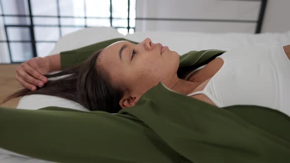 Side View Closeup of Sensual African American Slim Woman Lying on Bed Looking Up and Turning Posing