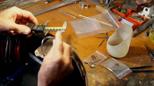 Goldsmith preparing bangle