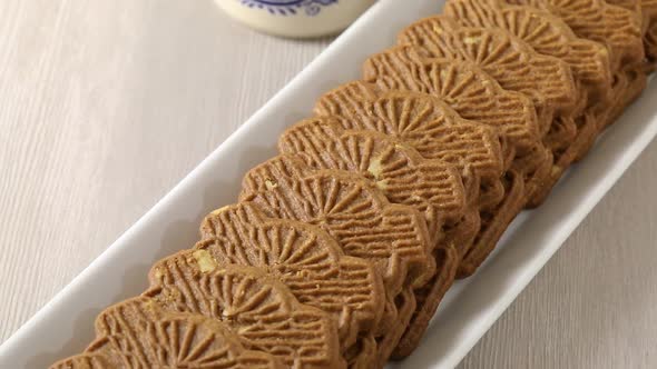 Traditional fresh baked Dutch cookies called speculaas in the shape of a windmill close up