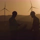 Engineers Review Information in Tablet, Turning Head Towards Windmill at Sunset - VideoHive Item for Sale