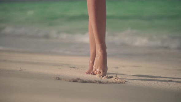 Legs Draws Heart In Sand On Tropical Beach.Girl Made Heart From Foot.Fingers Made Love Sign