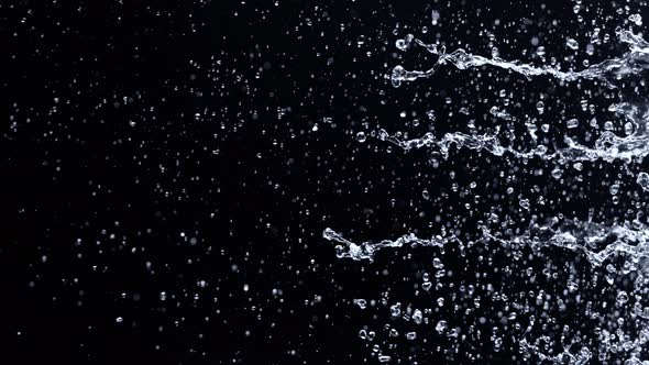 Super Slow Motion Shot of Water Side Splash Isolated on Black Background at 1000Fps