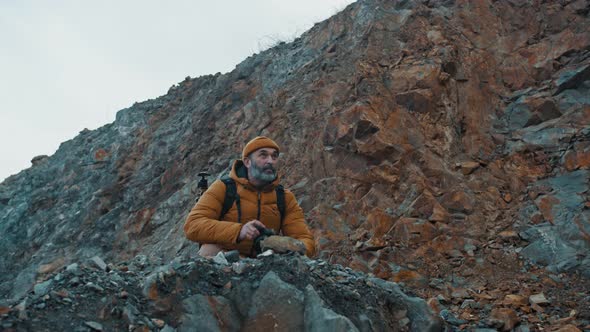 Traveller with Backpack Entering the Scene Taking Picture of Landscape Using Camera