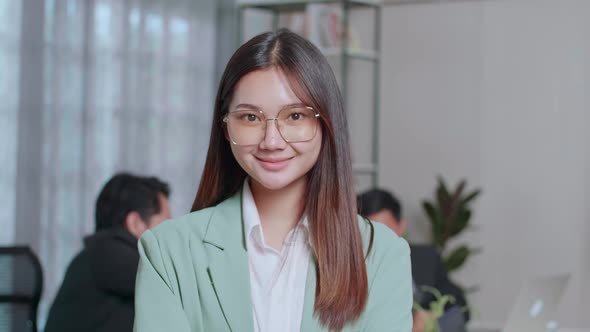 Portrait Of Young Asian Business Woman Standing With Folded Arms At Office