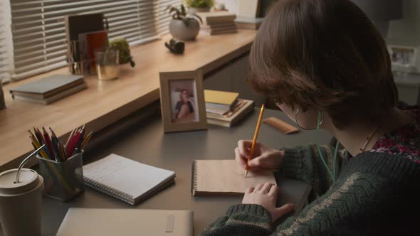 Sick Girl Drawing at Desk