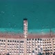 Aerial Top View of Beach with Sunshade and People Swimming at Beautiful Blue Color Sea - VideoHive Item for Sale