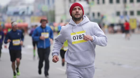 Male Runner on Marathon Race with Running Athletes