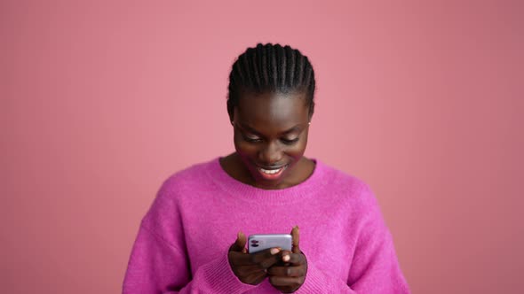 Smiling blonde woman hippie texting by phone