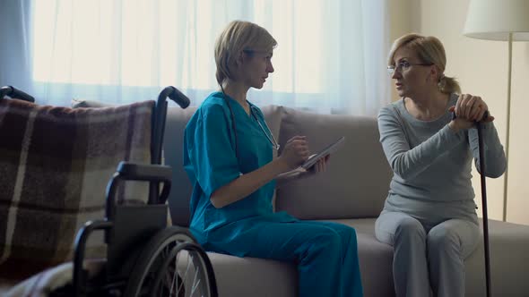 Experienced Therapist Typing Medical Data Tablet, Talking With Patient, Health