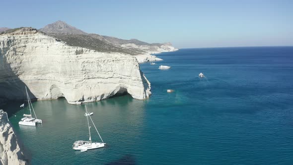 Aerial View of Tropical Island with White Rocks and Boats in Bay 