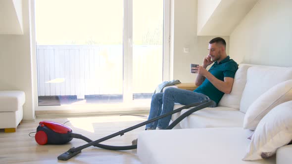 Man Calling on Smartphone After Cleaning Home 