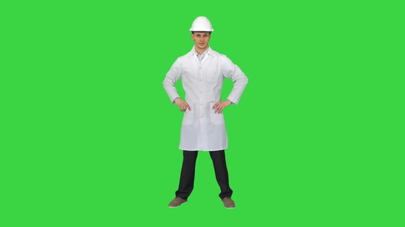 A Young Engineer Putting Dafety Hat on on a Green Screen, Chroma Key