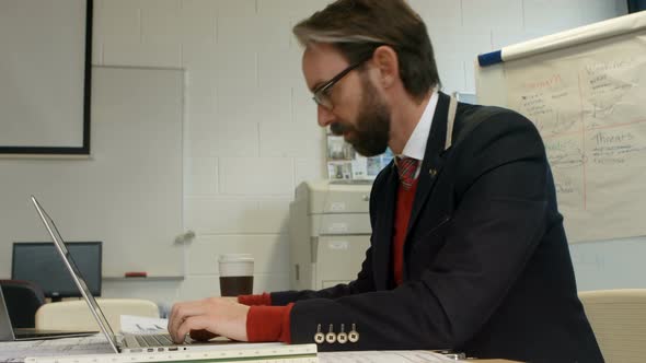 Businessman using laptop at desk 4k