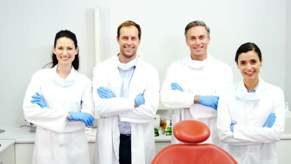 Smiling dentists standing with arms crossed