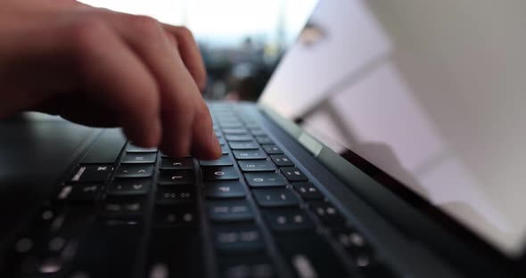 Male Hands are Typing on Laptop Keyboard