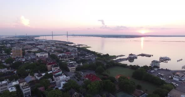 Charleston SC rooftops and harbor at sunrise