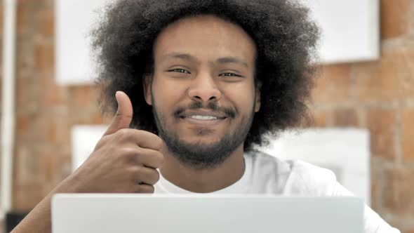 Thumbs Up By Man Working on Laptop