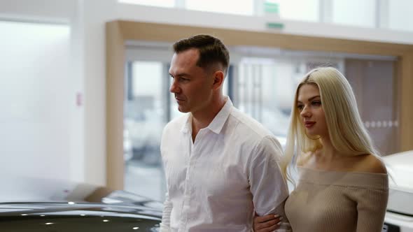 Man with Sexy Blonde Woman Came to Choose Car in Dealership