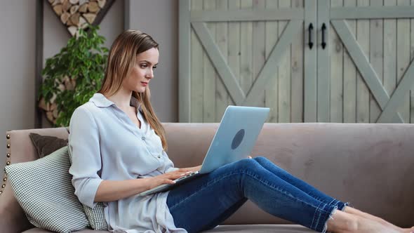 Pleasant Freelance Young Girl Looking at Screen of Notebook