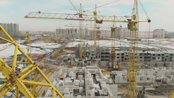 Project with White Buildings and Large Construction Cranes
