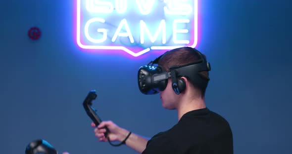 Man Plays Games on a Virtual Reality Console