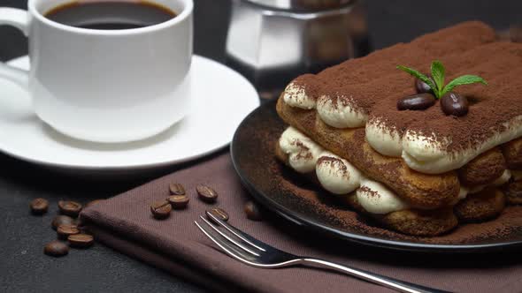 Classic Tiramisu Dessert on Ceramic Plate, Milk or Cream and Cup of Coffee on Concrete Background