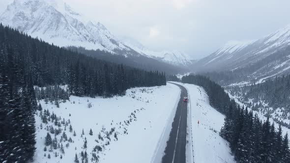 Drone captures midwinter trailer journey through mountainous area of Kananaskis, Alberta, Canada