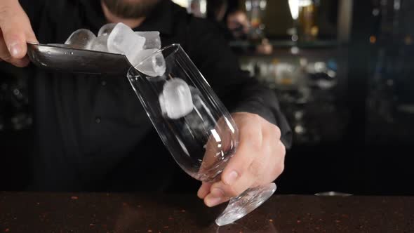 Ice Cubes Falling Into Empty Transparent Glass