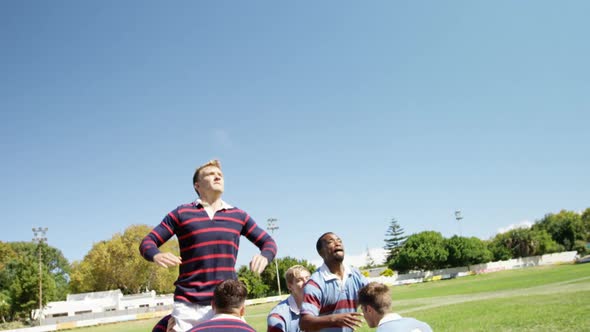 Rugby players practicing to defend the ball